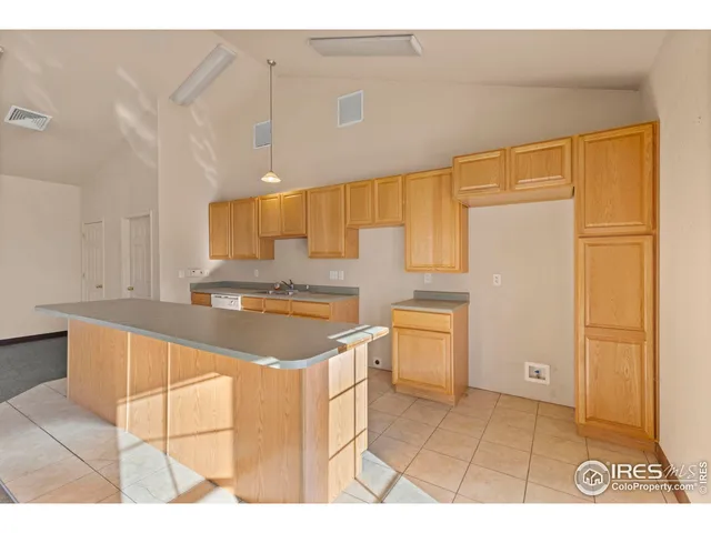 a kitchen with a sink cabinets and a stove top oven