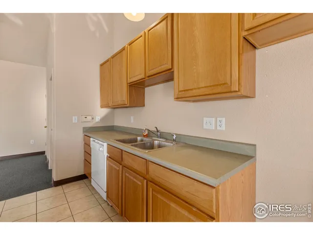 a view of a hallway with closet and a living room