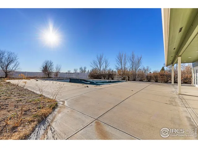 a view of a balcony with wooden floor and seating space