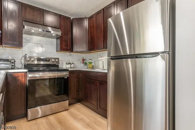 a kitchen with a refrigerator sink and stove