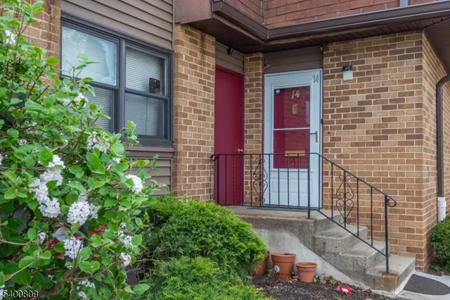 a view of a brick house with a yard