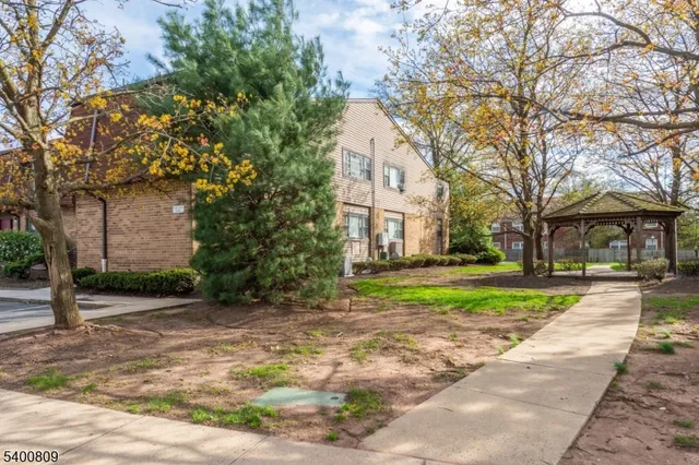 a view of a house with a yard and tree s