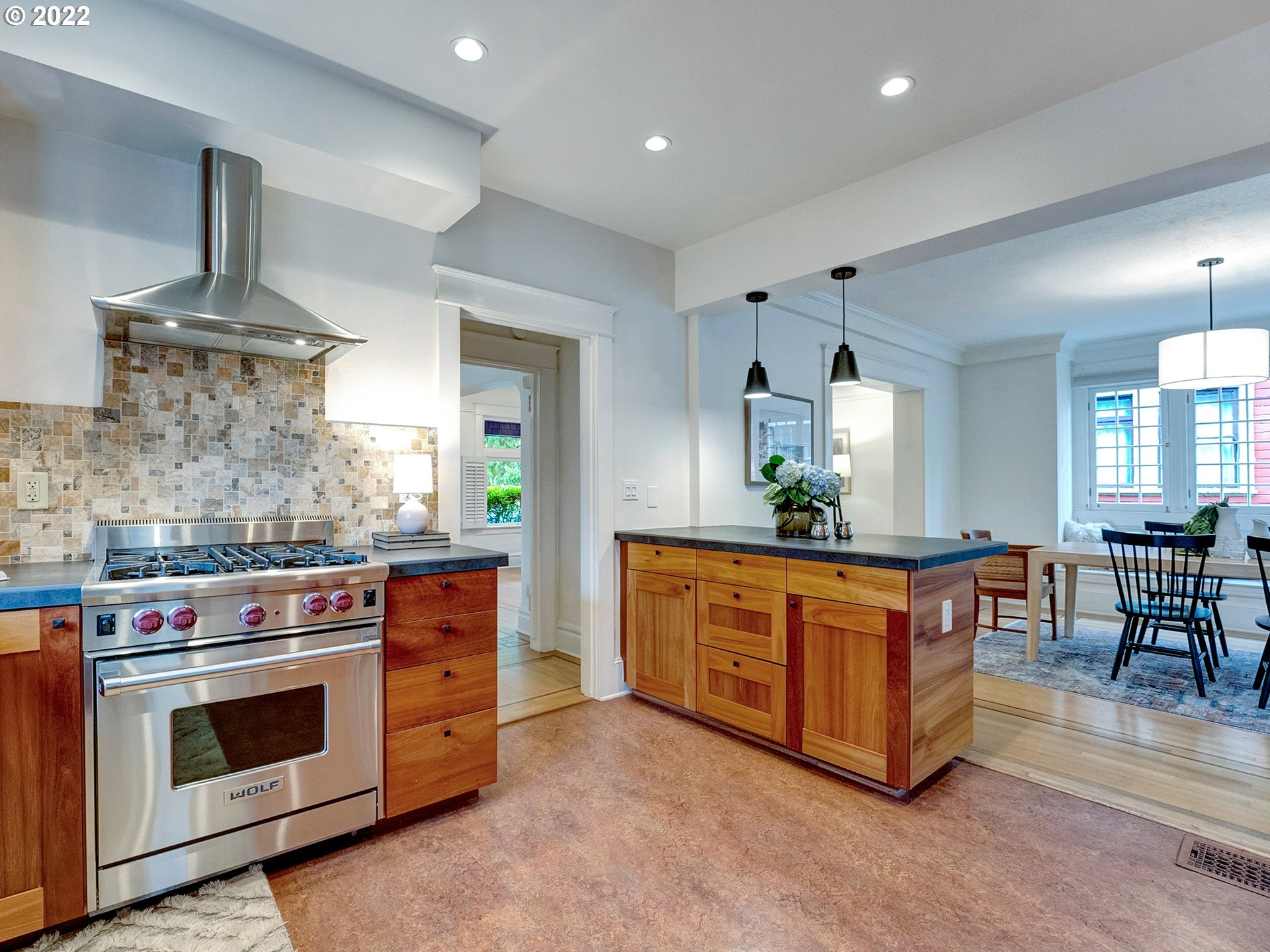 2307 Northeast Couch Street Portland, OR 97232 - Photo 12 of 32 a large kitchen with stainless steel appliances granite countertop a stove and a wooden floors