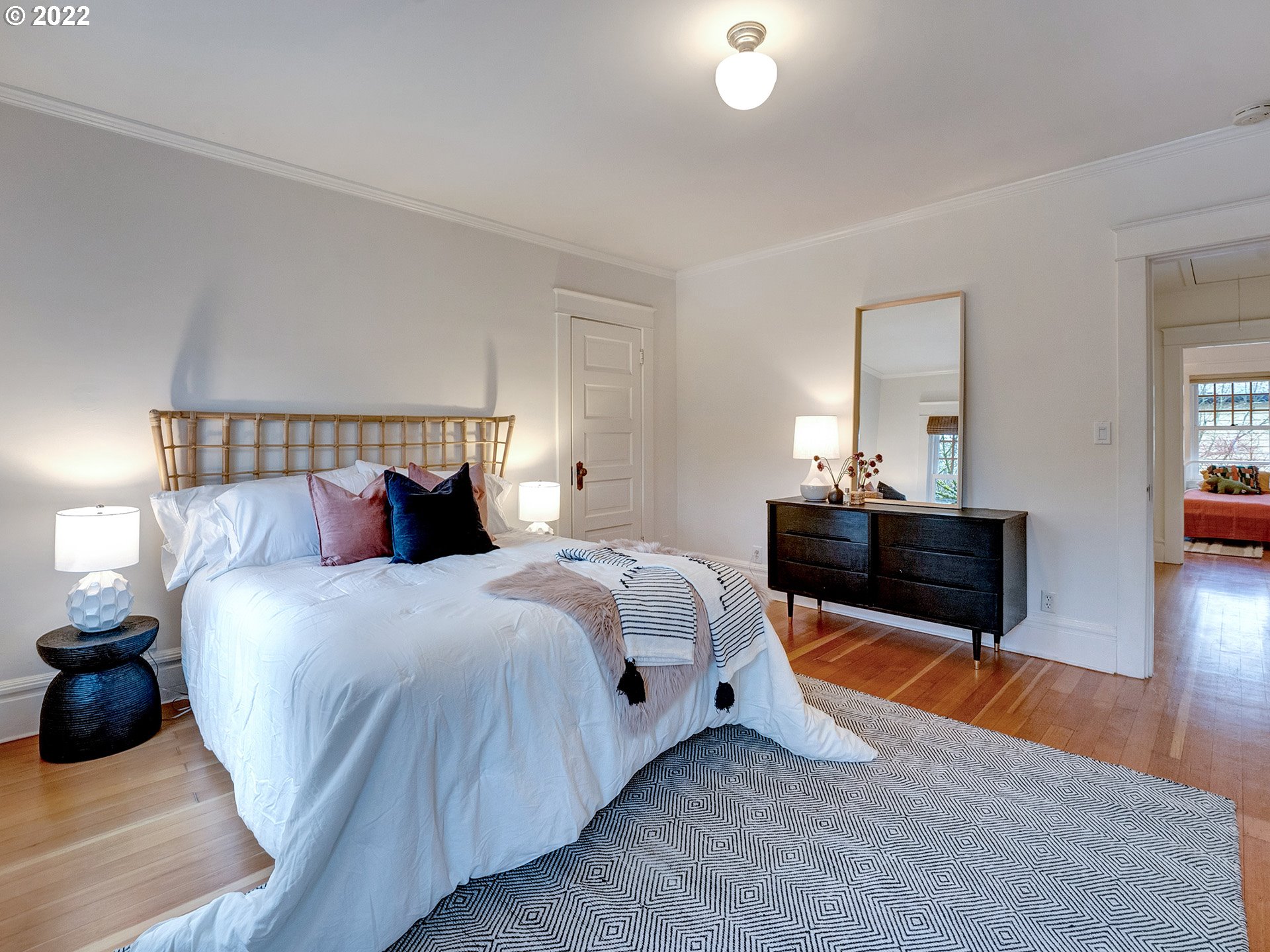2307 Northeast Couch Street Portland, OR 97232 - Photo 16 of 32 a bedroom with bed and wooden floor