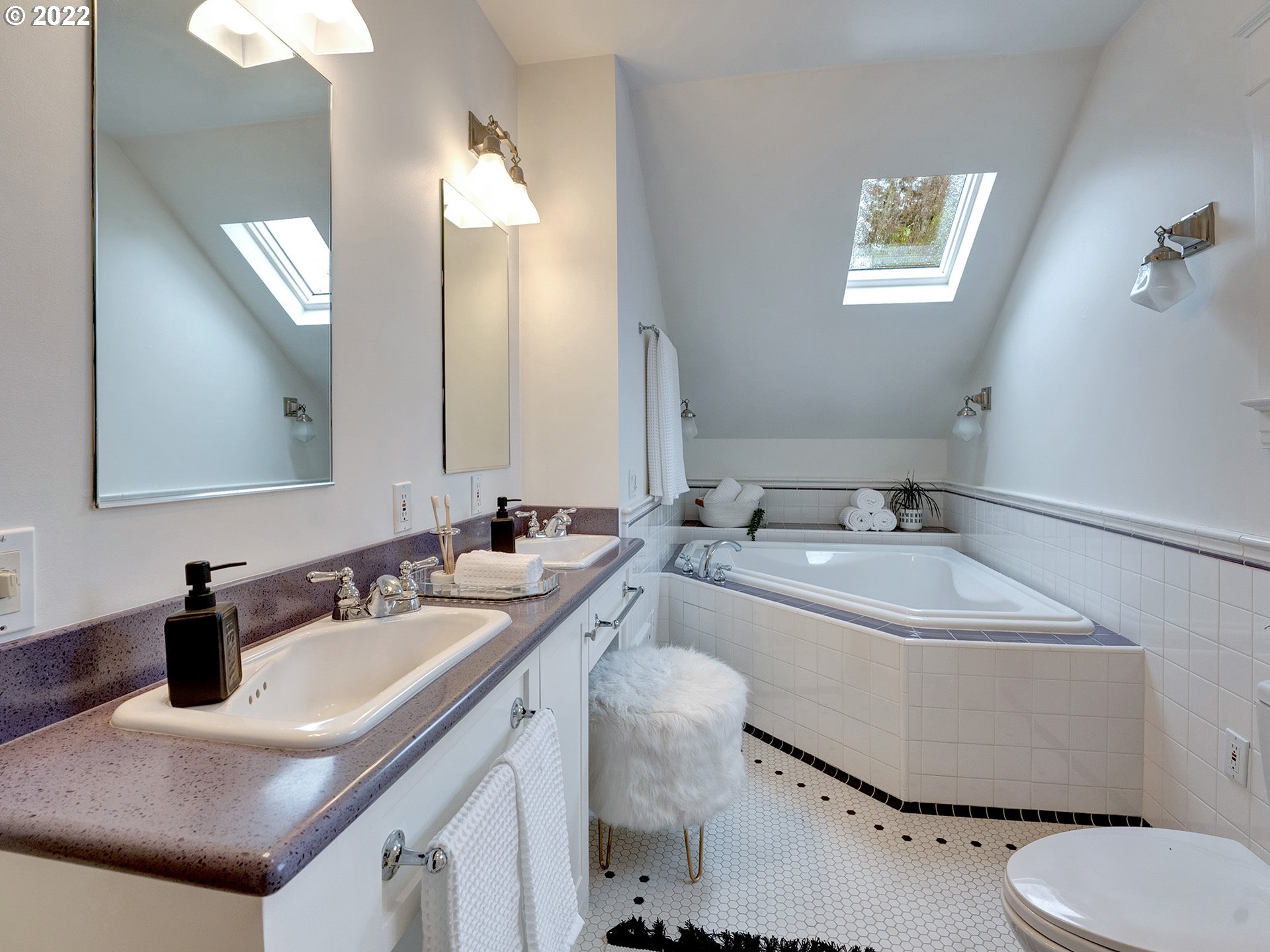 2307 Northeast Couch Street Portland, OR 97232 - Photo 20 of 32 a bathroom with a sink toilet a mirror and vanity