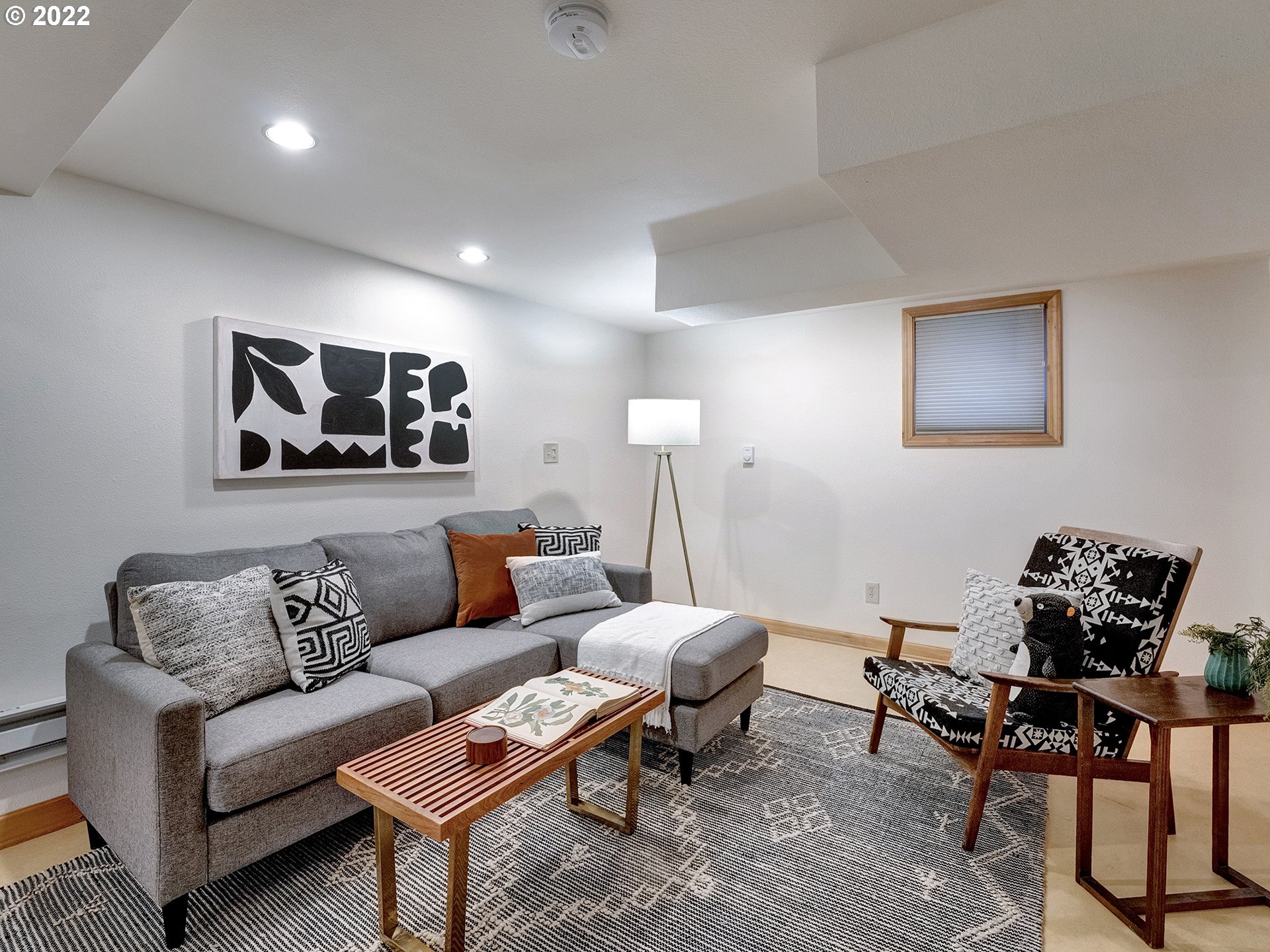 2307 Northeast Couch Street Portland, OR 97232 - Photo 22 of 32 a living room with furniture a rug and a painting