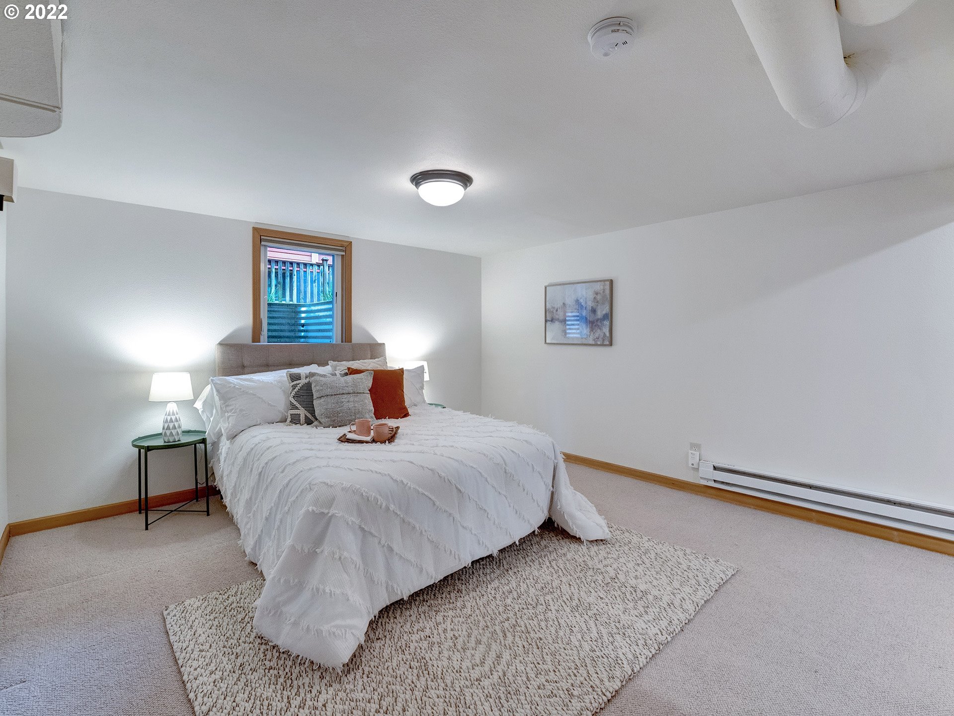 2307 Northeast Couch Street Portland, OR 97232 - Photo 25 of 32 a bedroom with bed and a night stand