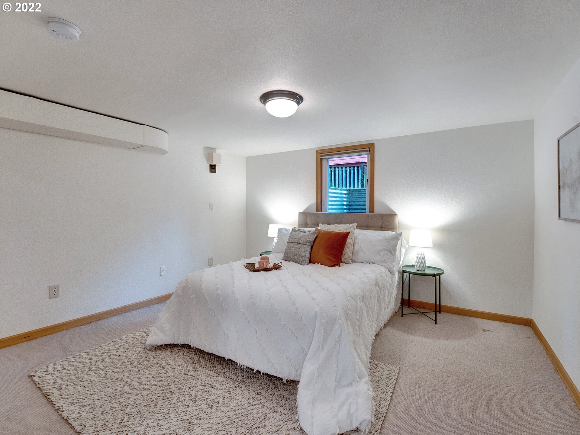 2307 Northeast Couch Street Portland, OR 97232 - Photo 26 of 32 a bedroom with a bed and a night stand
