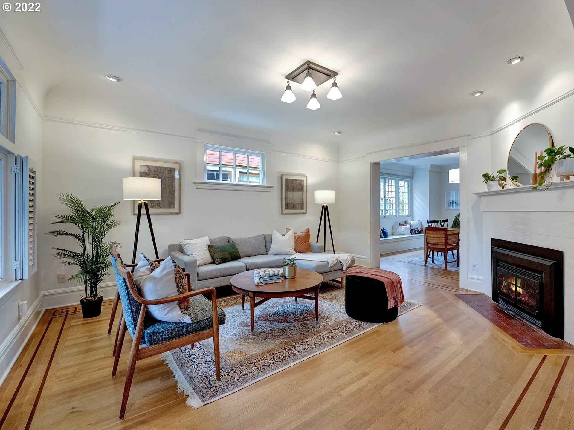 2307 Northeast Couch Street Portland, OR 97232 - Photo 3 of 32 a living room with furniture a chandelier and a fireplace
