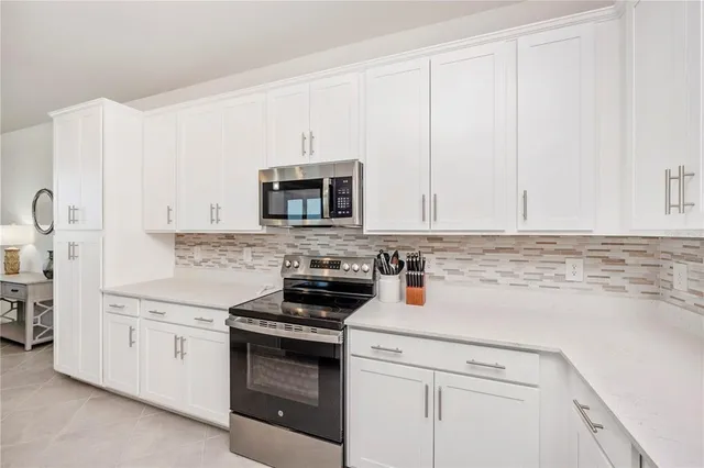 a living room with furniture and kitchen view