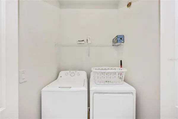 a swimming pool view with a seating space and a garden view