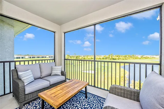 a front view of a house with glass windows and furniture