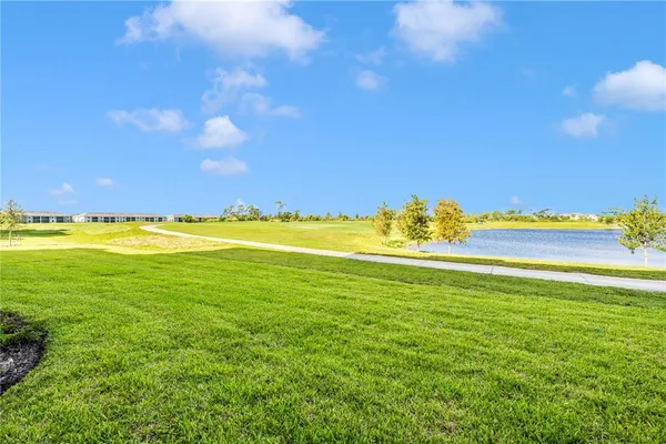 a view of a golf course with an ocean