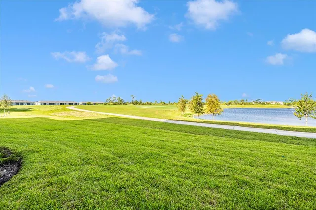 a view of a golf course with an ocean