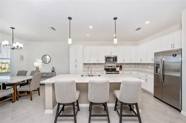 a kitchen with a sink and a stove top oven