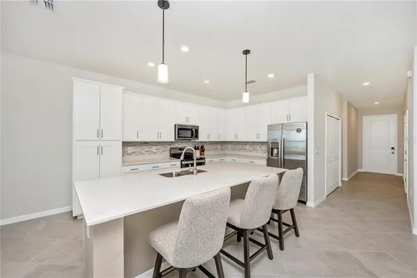 a kitchen with white cabinets and white appliances