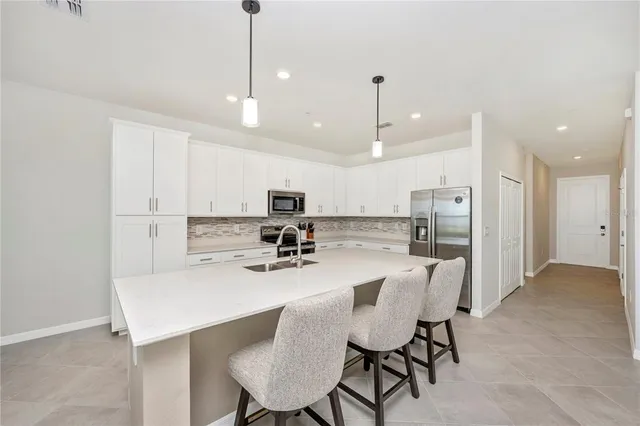 a kitchen with white cabinets and white appliances