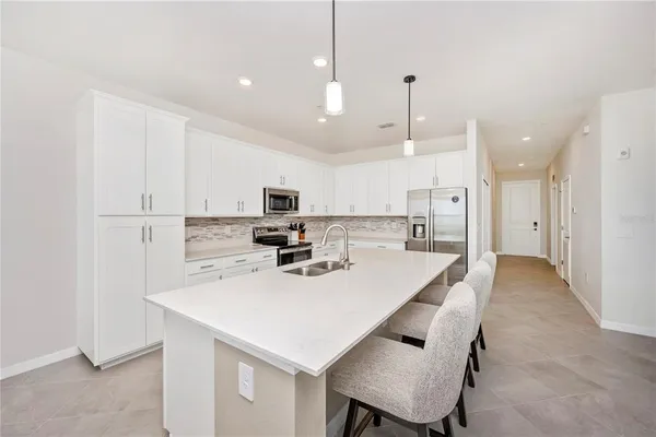 a dining room with furniture a chandelier and window