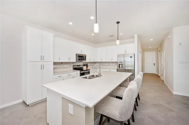 a dining room with furniture a chandelier and window