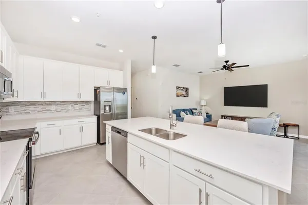 a kitchen with a table chairs stove and wooden floor