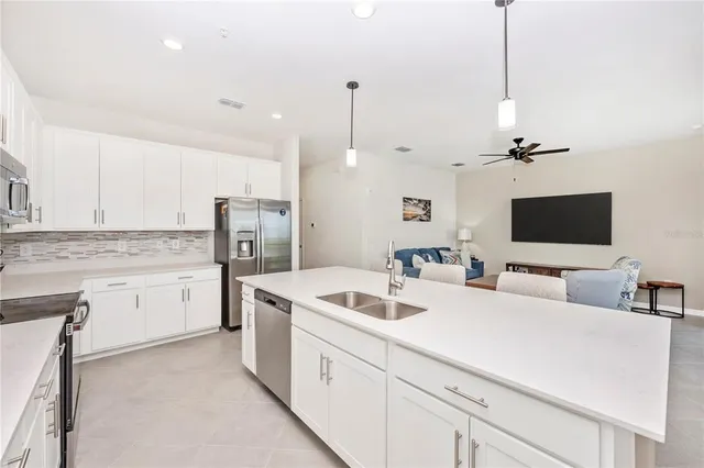 a kitchen with a table chairs stove and wooden floor