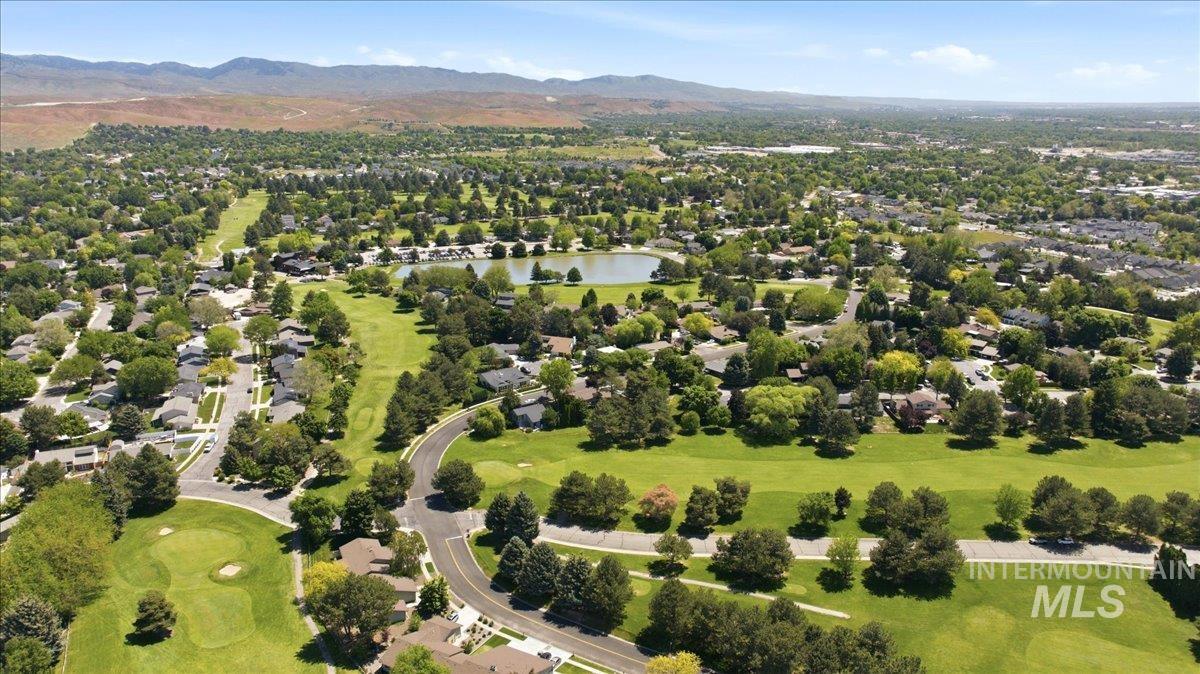599 Pebble Beach Way Eagle, ID 83616 - Photo 41 of 44 Aerial landscape featuring a manicured golf course, a prominent body of water, and residential properties surrounded by mature trees