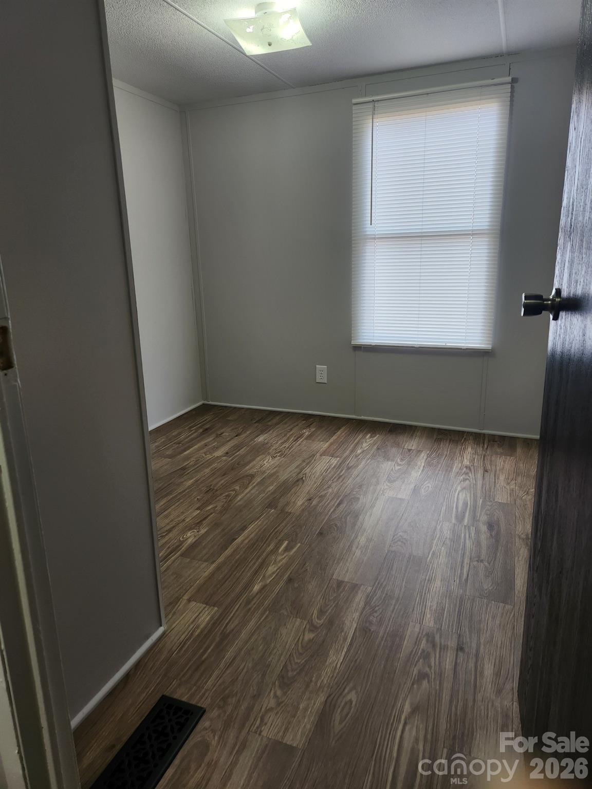 450 Ridgeland Drive Cleveland, NC 27013 - Photo 13 of 14 an empty room with wooden floor and windows