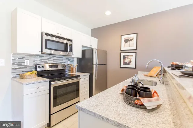a kitchen with a stove and a refrigerator