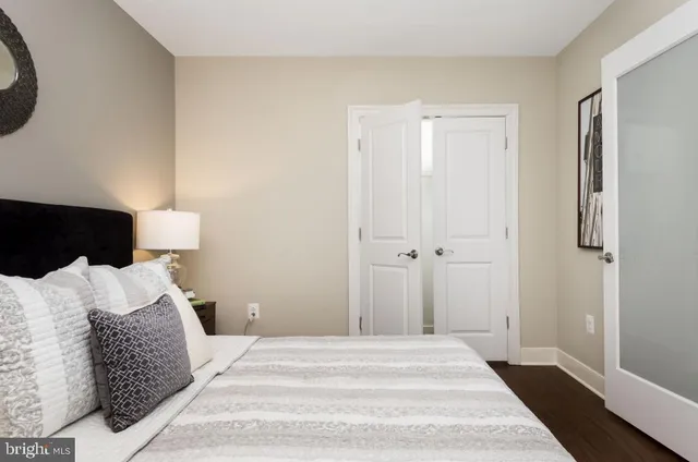 a bedroom with a bed and a lamp