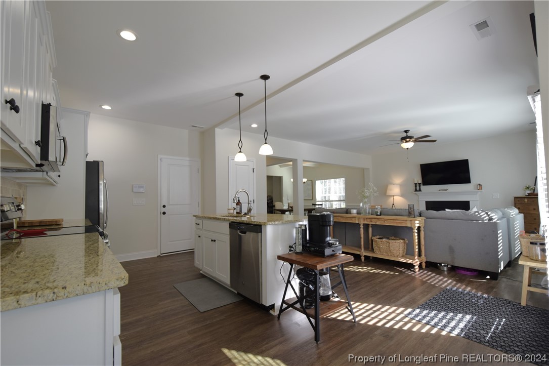 2015 Hayfield Road Wade, NC 28395 - Photo 23 of 50 a kitchen with a sink a counter top space appliances and cabinets