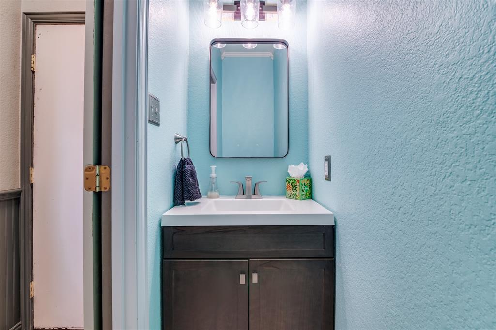 10702 Augusta Lane Rowlett, TX 75089 - Photo 11 of 25 a bathroom with a sink and a mirror