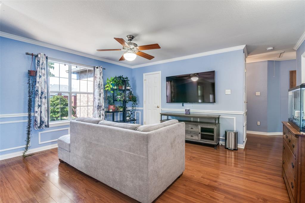10702 Augusta Lane Rowlett, TX 75089 - Photo 12 of 25 a living room with furniture and a flat screen tv