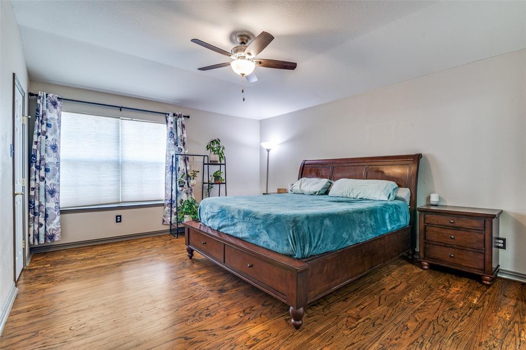 10702 Augusta Lane Rowlett, TX 75089 - Photo 14 of 25 a bedroom with a bed and window