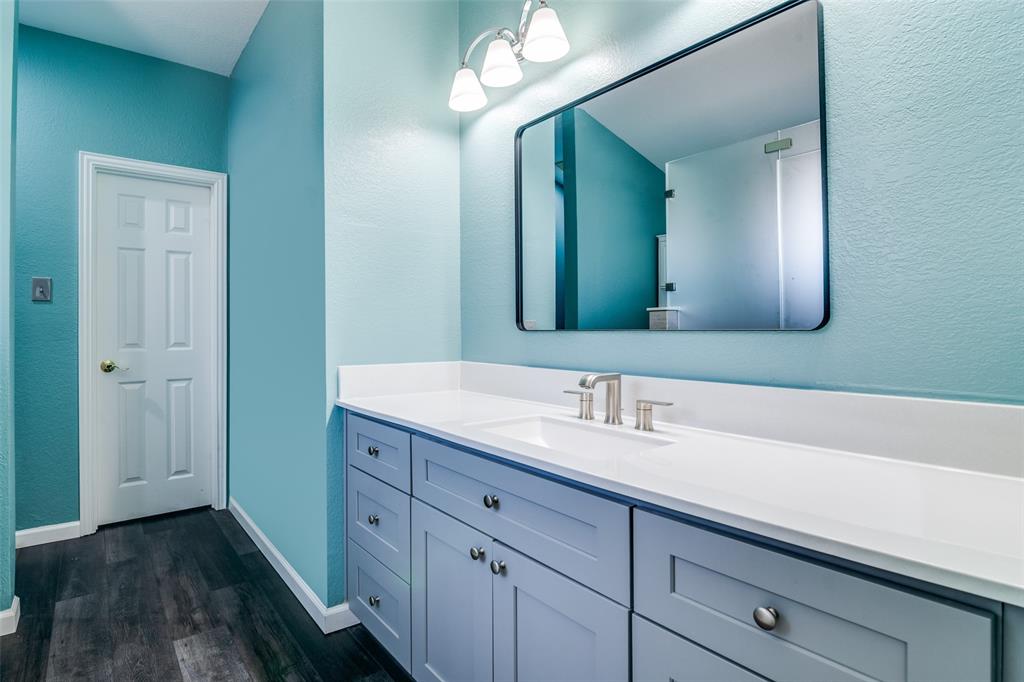 10702 Augusta Lane Rowlett, TX 75089 - Photo 16 of 25 a bathroom with a double vanity sink and a mirror