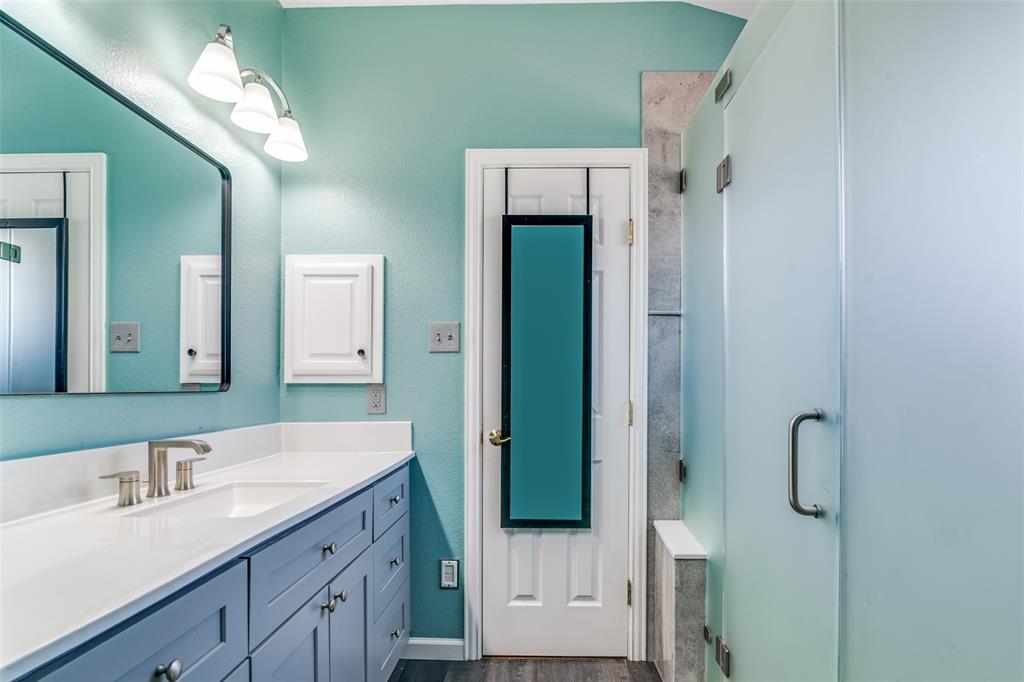 10702 Augusta Lane Rowlett, TX 75089 - Photo 17 of 25 a bathroom with a double vanity sink and a mirror