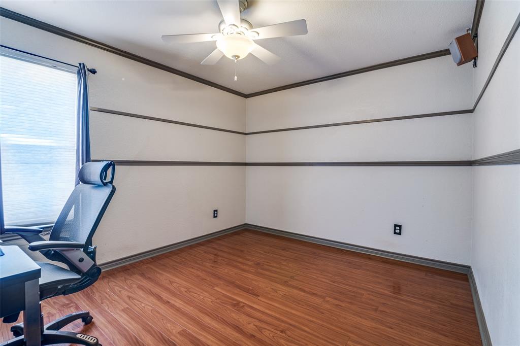 10702 Augusta Lane Rowlett, TX 75089 - Photo 18 of 25 a view of a room with wooden floor and white walls