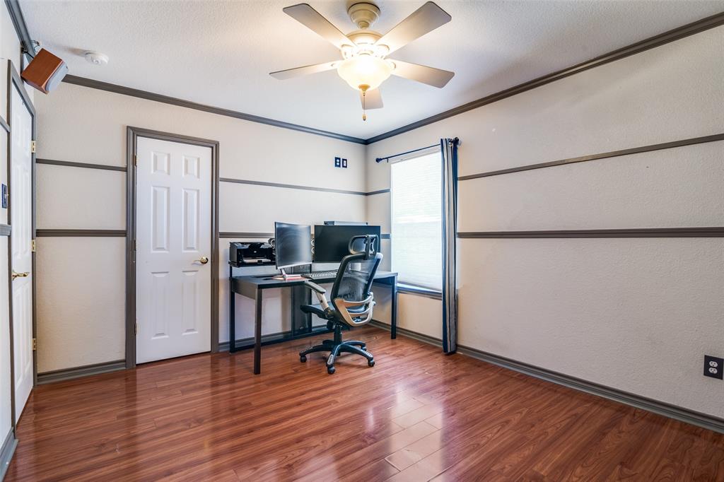 10702 Augusta Lane Rowlett, TX 75089 - Photo 19 of 25 a workspace with furniture wooden floor and a ceiling fan