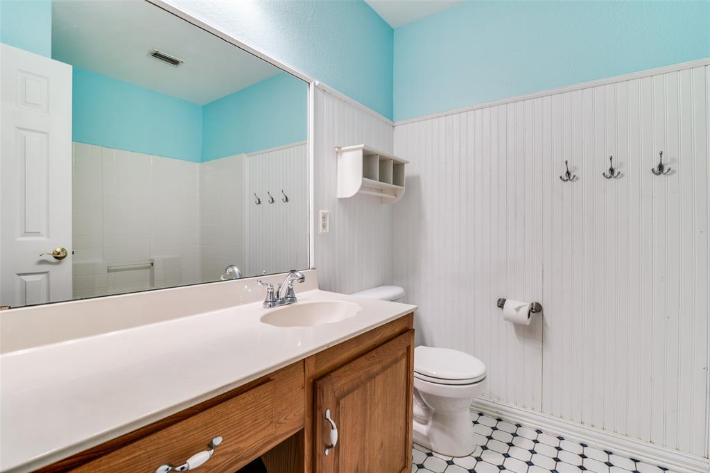 10702 Augusta Lane Rowlett, TX 75089 - Photo 20 of 25 a bathroom with a sink a toilet and shower