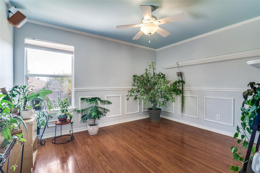 10702 Augusta Lane Rowlett, TX 75089 - Photo 21 of 25 a living room with furniture and a potted plant