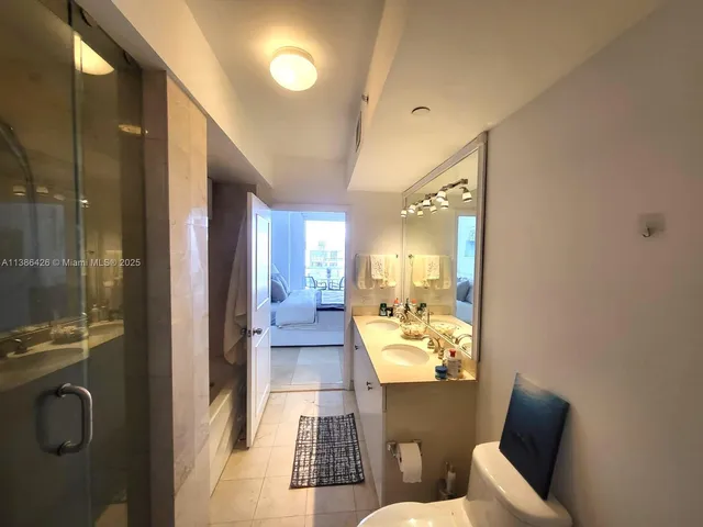 a bathroom with a toilet mirror and shower