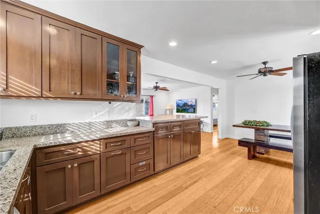 a kitchen with stainless steel appliances granite countertop wooden cabinets a sink and dishwasher