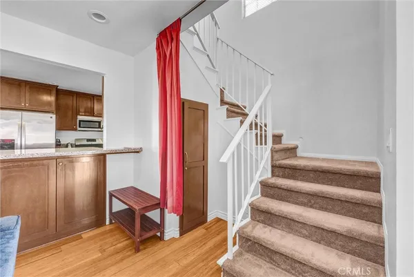 a view of entryway and hall with wooden floor