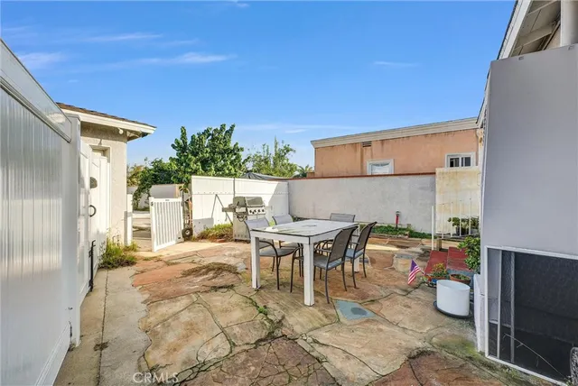 a view of a patio with table and chairs and potted plants