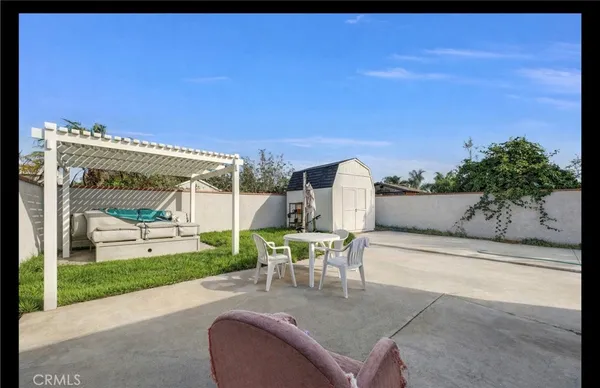 a view of a patio with table and chairs near a yard