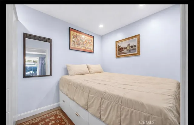 a bedroom with a bed and a painting on the wall