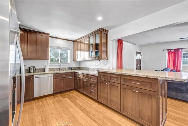 a kitchen with stainless steel appliances granite countertop a stove sink and cabinets