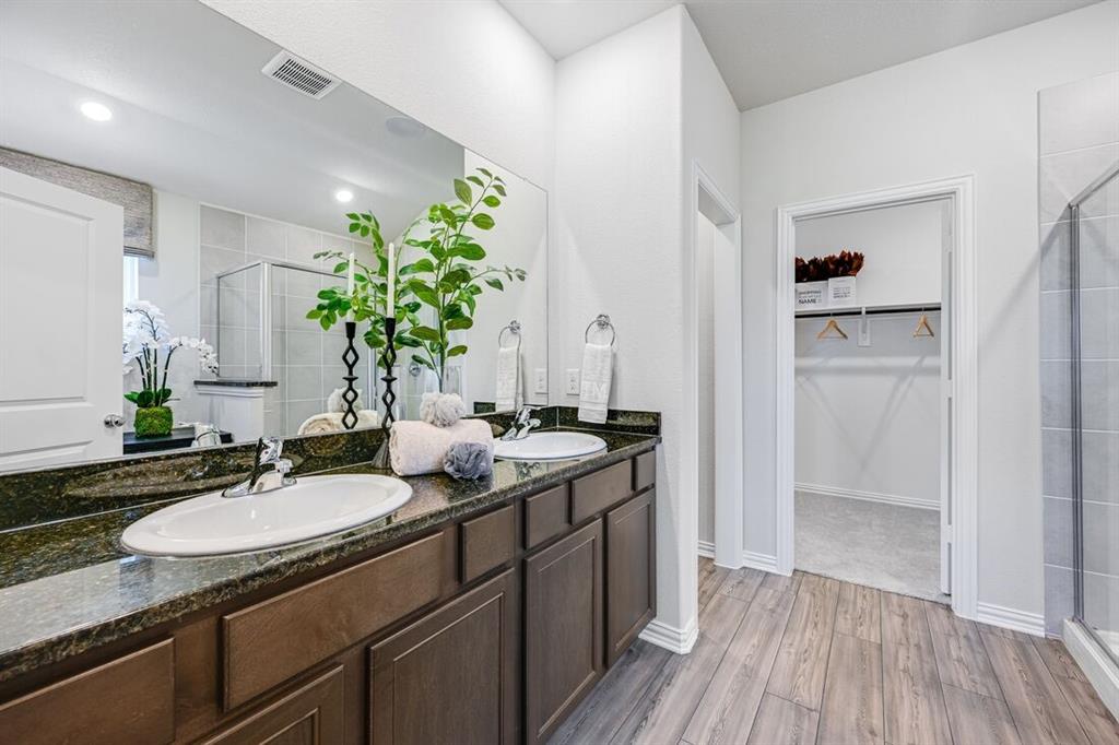 2621 Glacier Road Anna, TX 75409 - Photo 6 of 38 a bathroom with a granite countertop sink a mirror and a shower