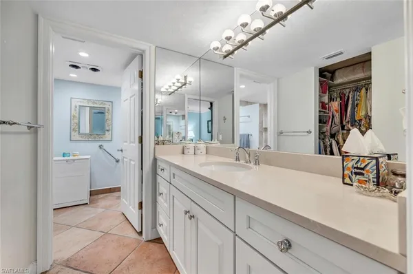 a spacious bathroom with a sink a mirror and a shower