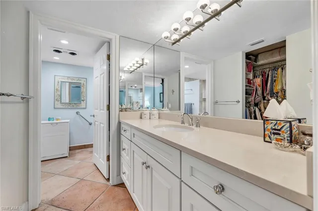 a spacious bathroom with a sink a mirror and a shower