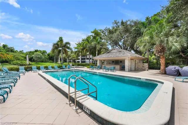 a view of a house with swimming pool and sitting area